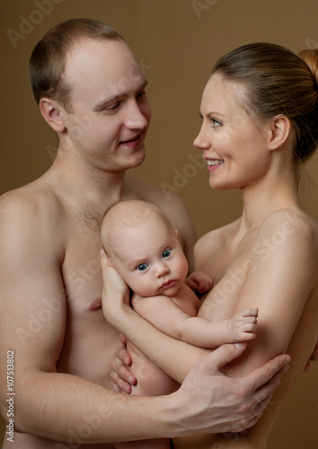 Happy family. Young parents and beautiful newborn son, hug with