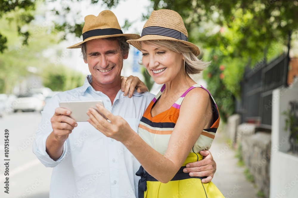 Happy couple looking at mobile phone Happy couple looking at mobile phone