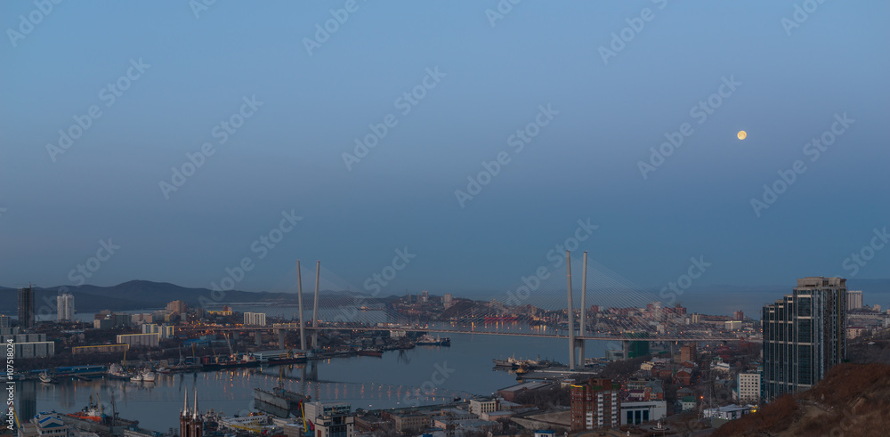 Vladivostok cityscape. Early morning. With moon in the sky. High-res photo.
