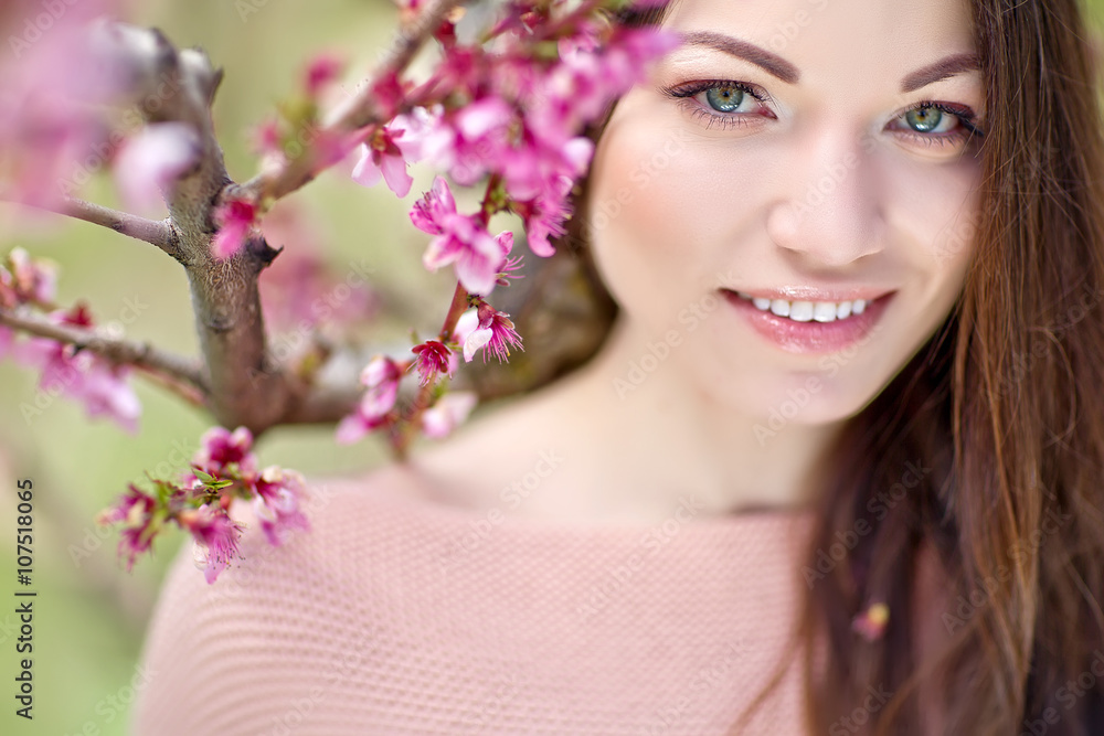 woman in a spring peach garden woman in a spring peach garden