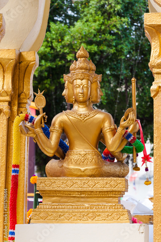golden four face Buddha statue