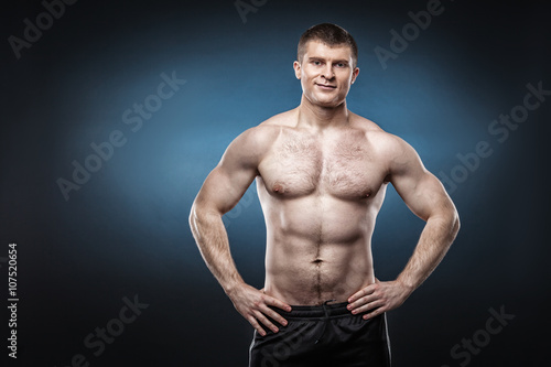 Sporty and healthy man isolated on dark blue background