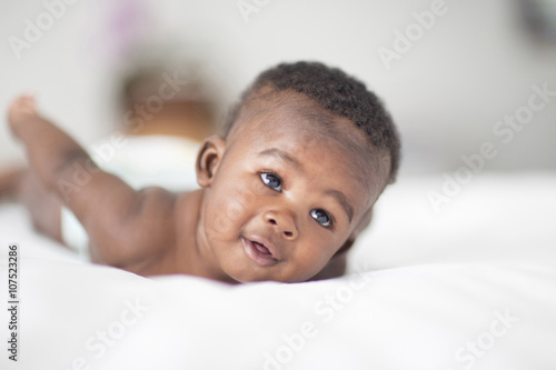 Close up of Black baby laying on bed