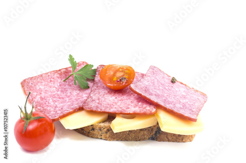 delicious sandwich of cold cuts of hard cheese and a tomato
