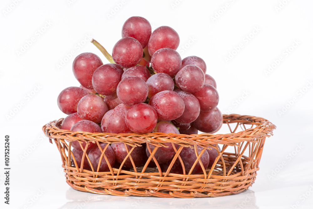 grapes in a basket isolated on white background grapes in a basket isolated on white background