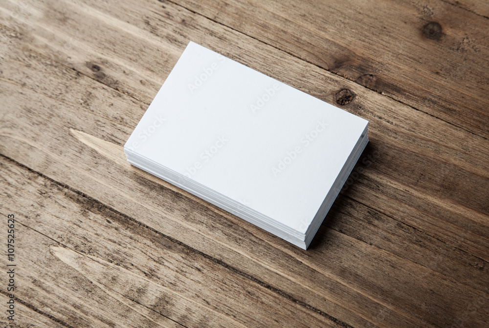 Photo of white identity stack. Empty business cards on wood table background, ready for your personal information. Horizontal mockup Photo of white identity stack. Empty business cards on wood table background, ready for your personal information. Horizontal mockup