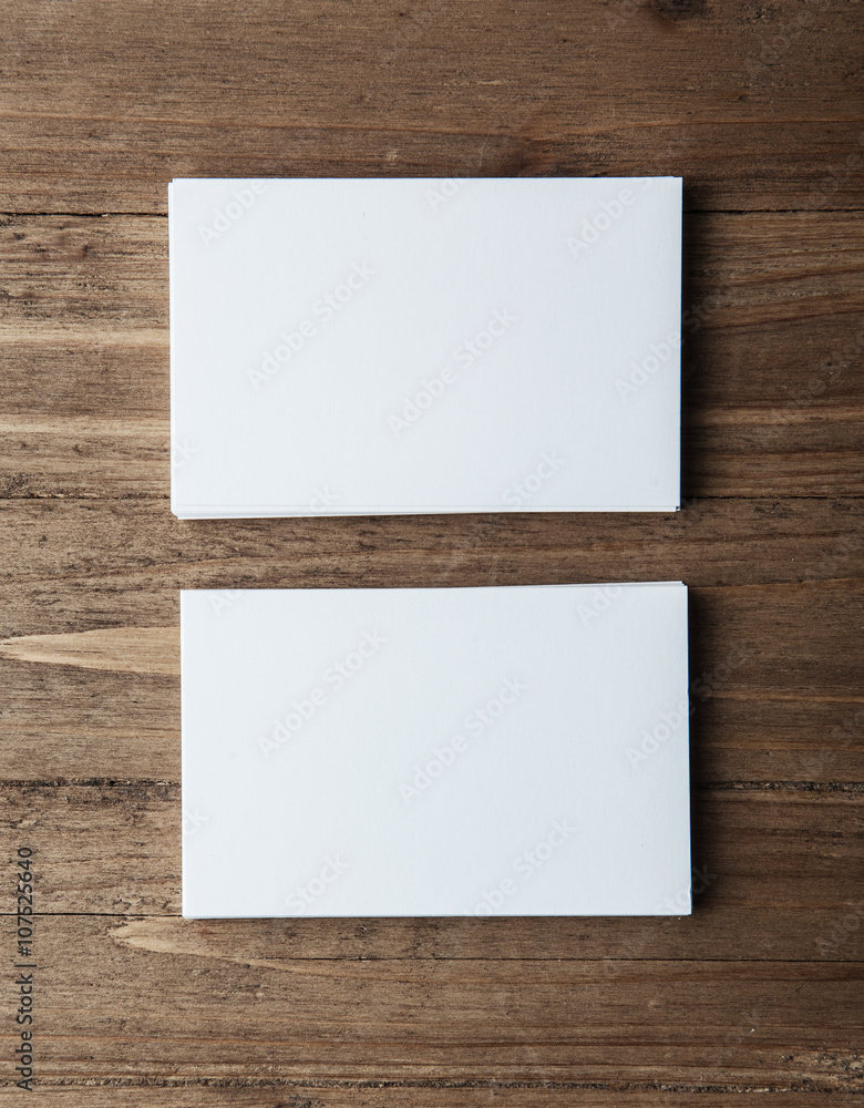Photo of two blank stack business cards. Empty cardS on wood table background, ready for your private information. Vertical mockup    