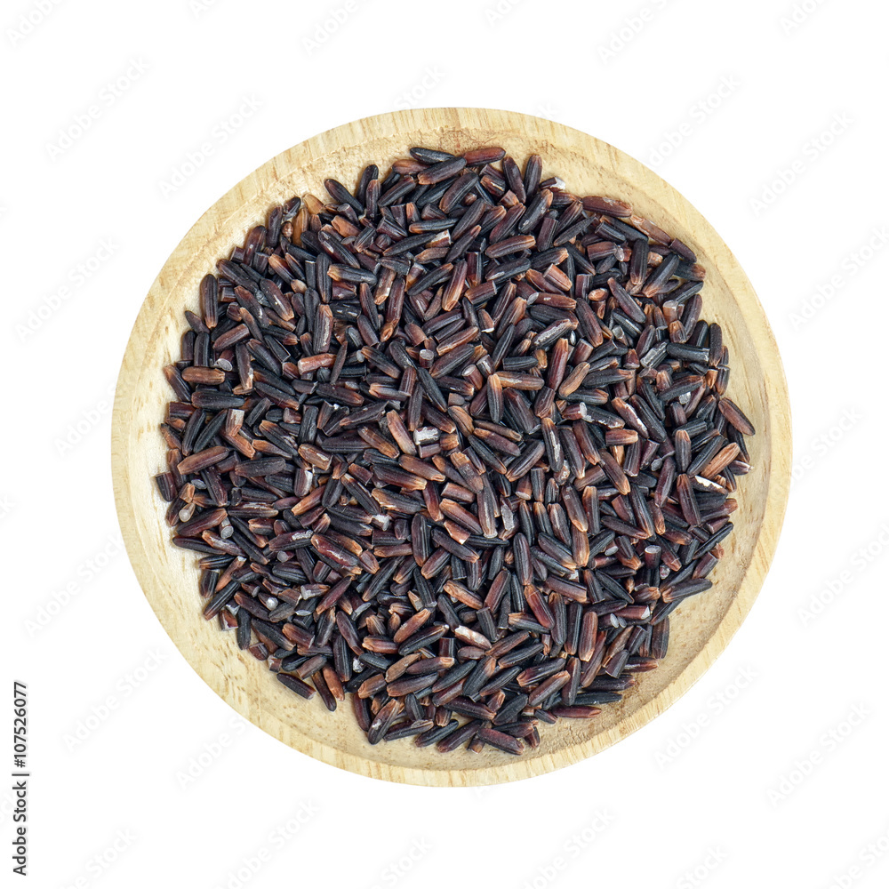 Black rice heap in wooden bowl on white background Black rice heap in wooden bowl on white background