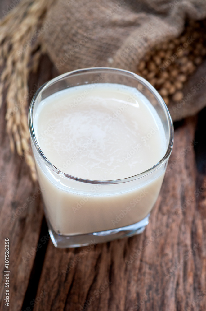 Soy milk in white glass on wooden background Soy milk in white glass on wooden background