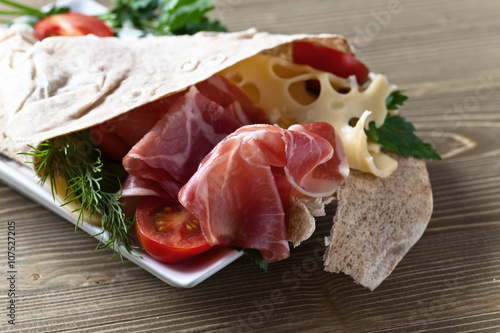 jamon with cheese, tomatoes and greens