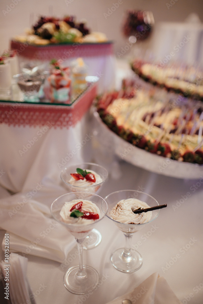 Delicious creamy desserts at wedding reception candy bar closeup