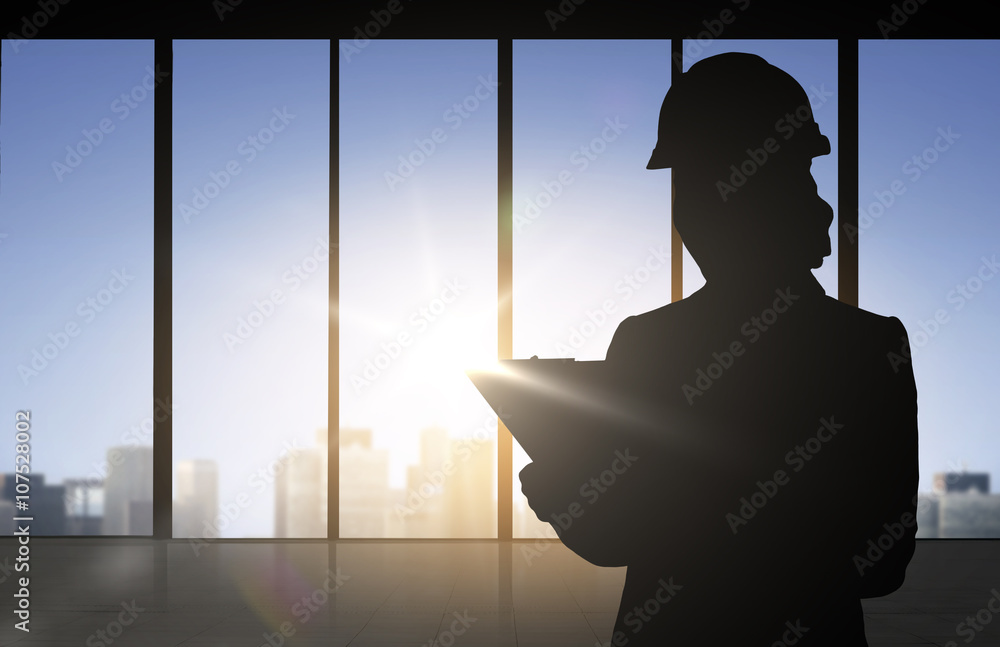 Fototapeta premium silhouette of woman in helmet with clipboard