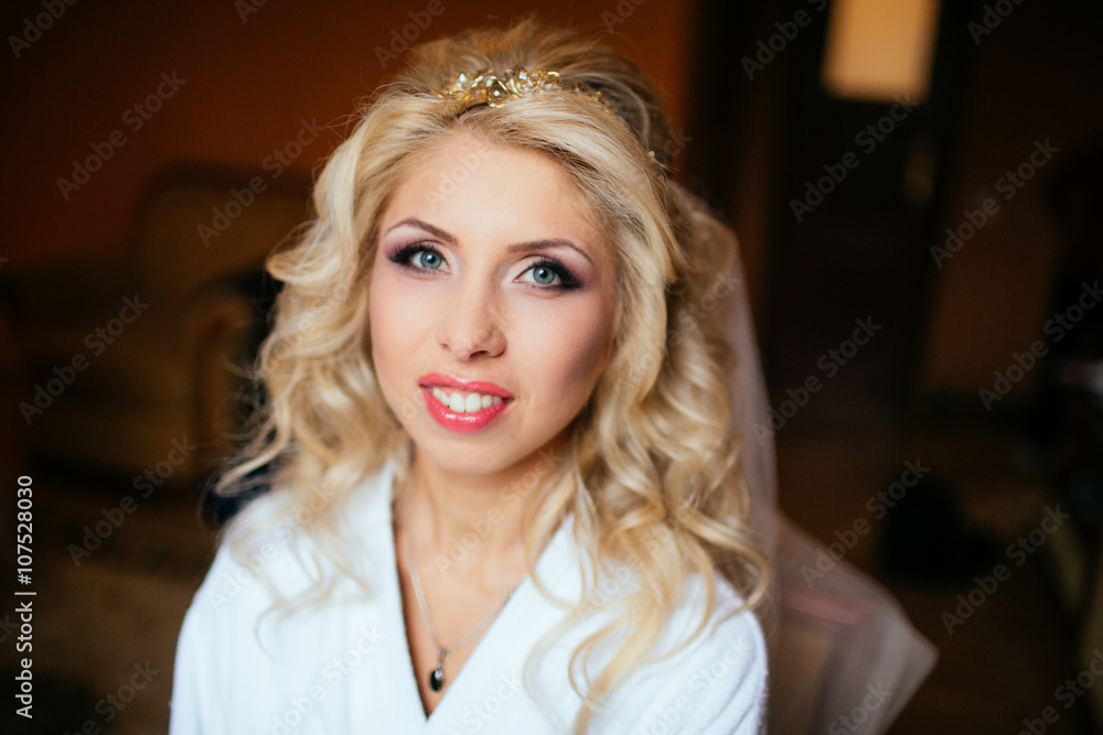Fototapeta premium Professional makeup artist getting ready blonde bride for weddin