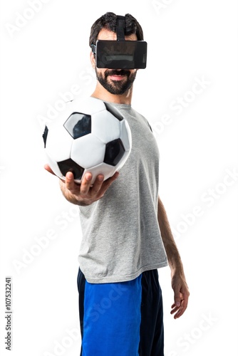 Man playing soccer using VR glasses