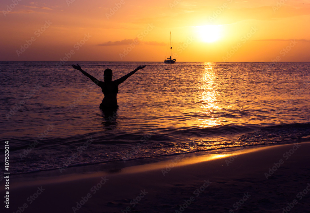 woman enjoying the sunset on the beach