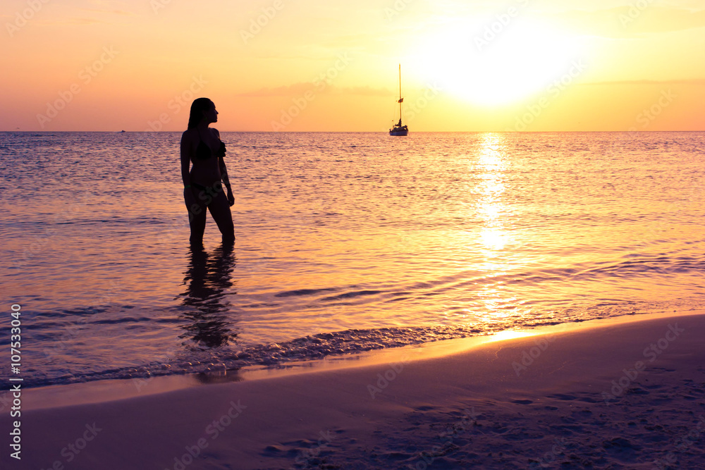 woman enjoying the sunset on the beach