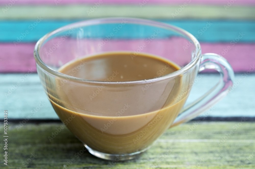 coffee cup on colorful wooden panel. coffee cup on colorful wooden panel.
