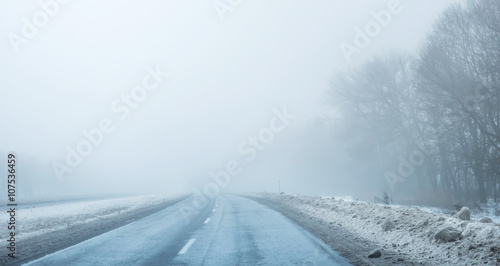 foggy road with dirty snow on sides © Ievgen Skrypko