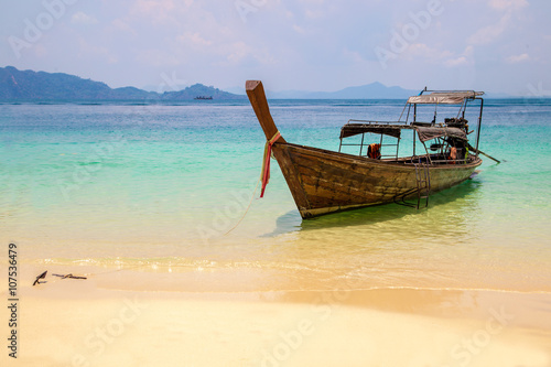 Fisherman wooden boat on sea coast with turquoise water © icedmocha