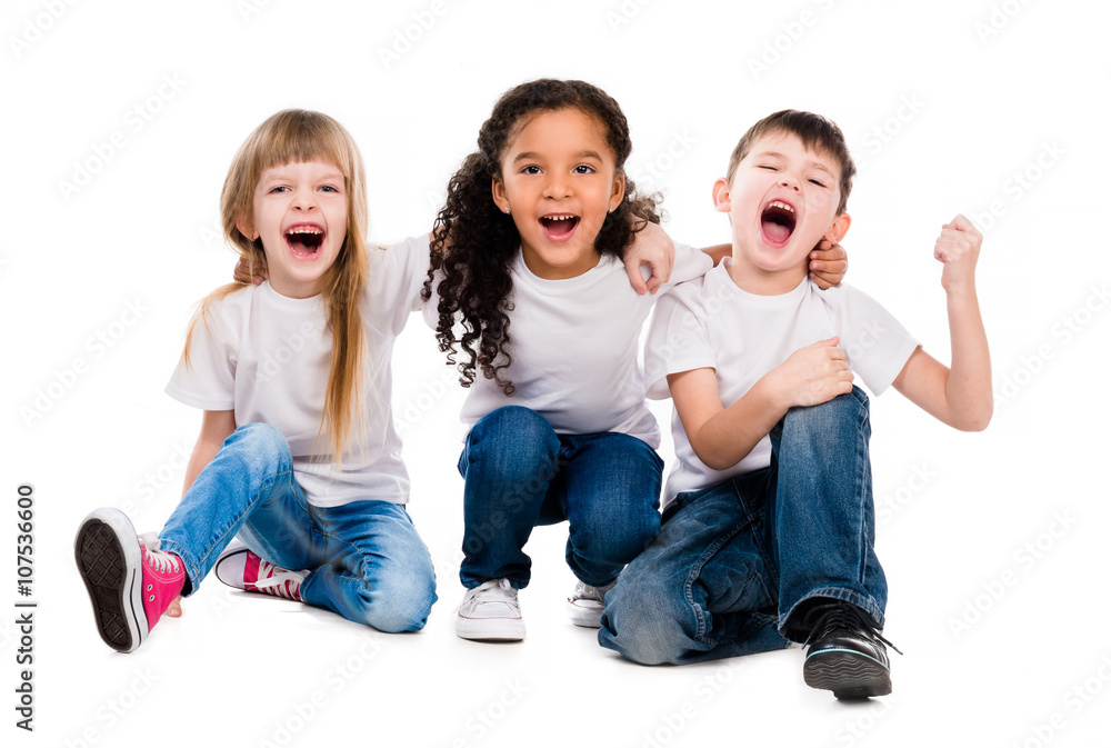 three funny trendy children laugh sitting on the floor three funny trendy children laugh sitting on the floor