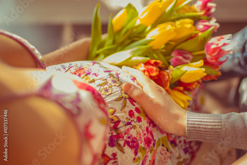 Pregnant in the pink dress with tulips