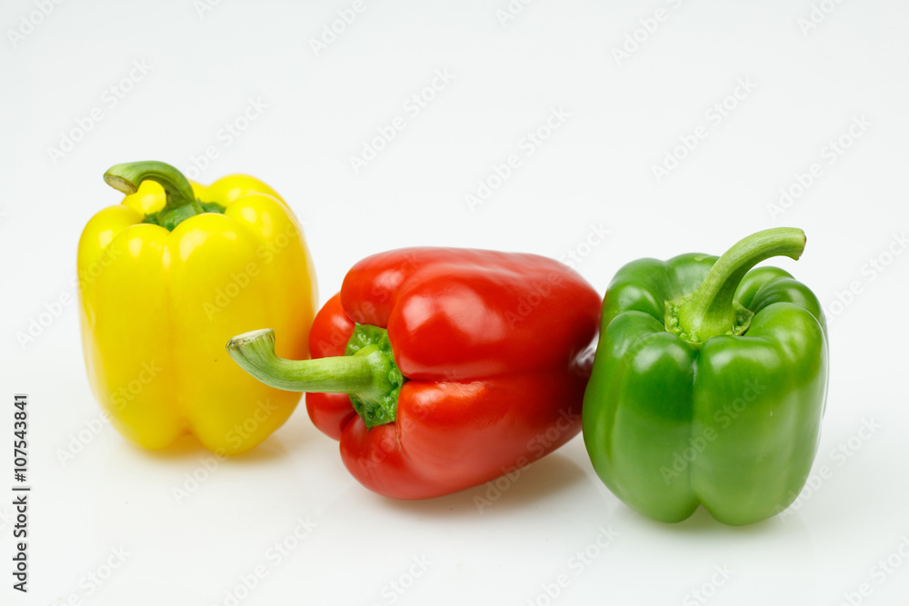 Three colorful bell peppers, on white background. Three colorful bell peppers, on white background.