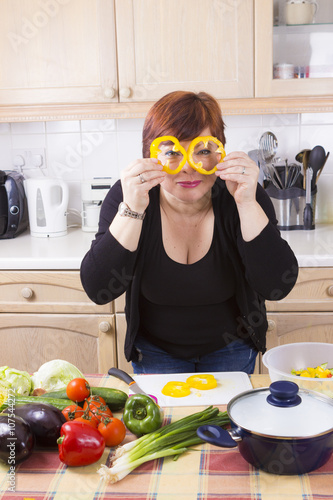 Middle age housewife cooking vegetables