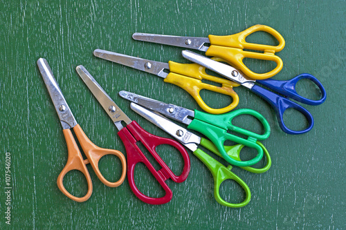 scissors on green wooden table