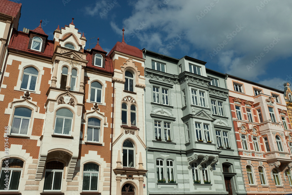 different wilhelminian style facades of apartment buildings in beautiful sunlight