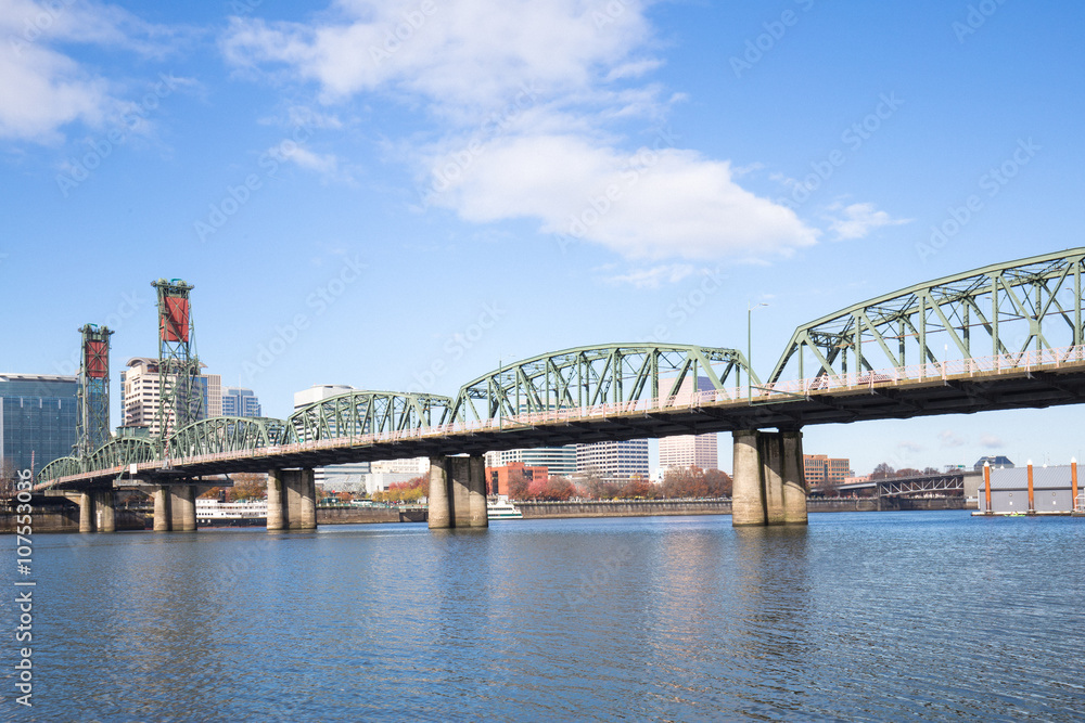 steel bridge over water with cityscape and skyline in portland