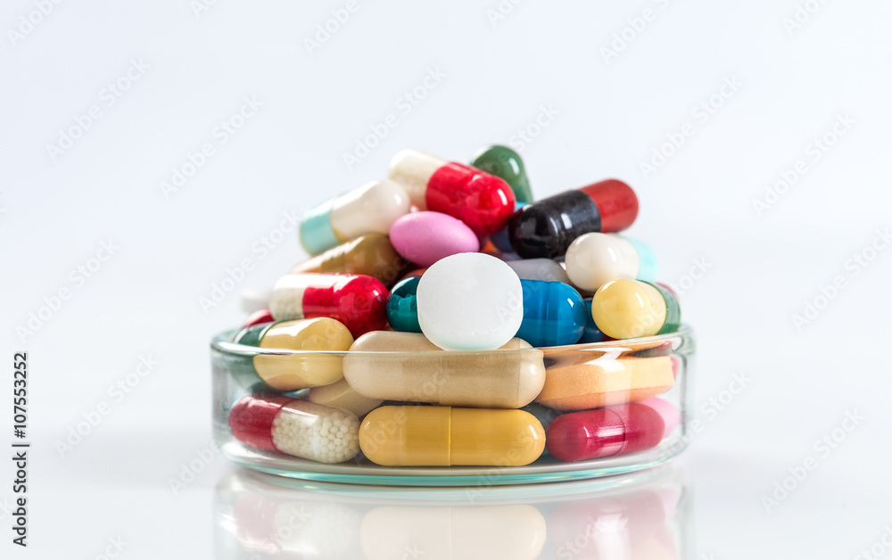 Various pills and capsules in glass containers symbole of medince addict Various pills and capsules in glass containers symbole of medince addict