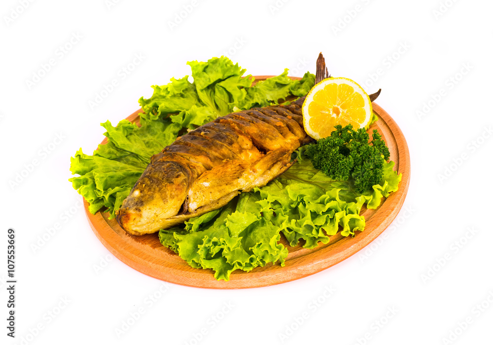fish with lemon, parsley on kitchen board on a white background fish with lemon, parsley on kitchen board on a white background