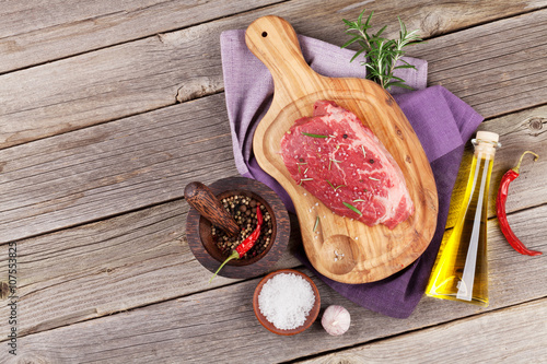 Raw beef steak with spices and herbs