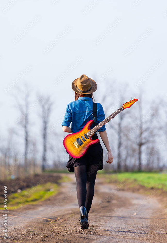 Naklejka premium photo of young woman with guitar