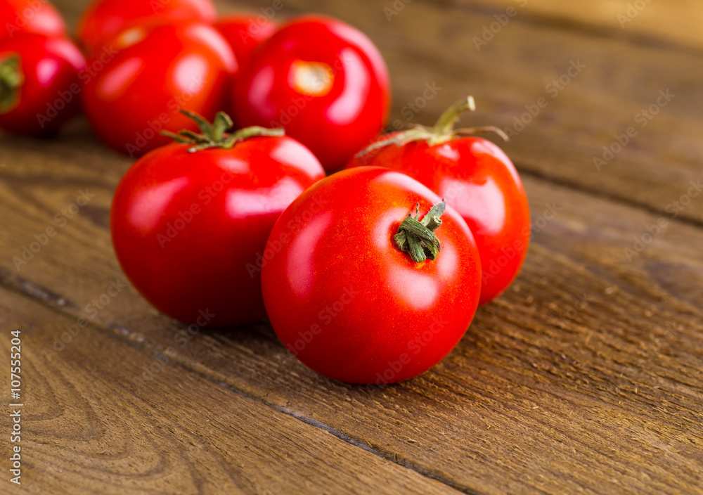 Tomatoes, cooked with herbs for the preservation on the old wood Tomatoes, cooked with herbs for the preservation on the old wood
