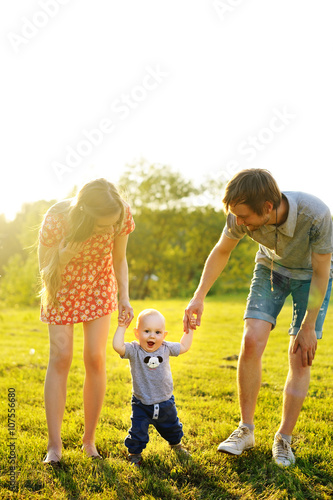 Happy family goes for a walk in park