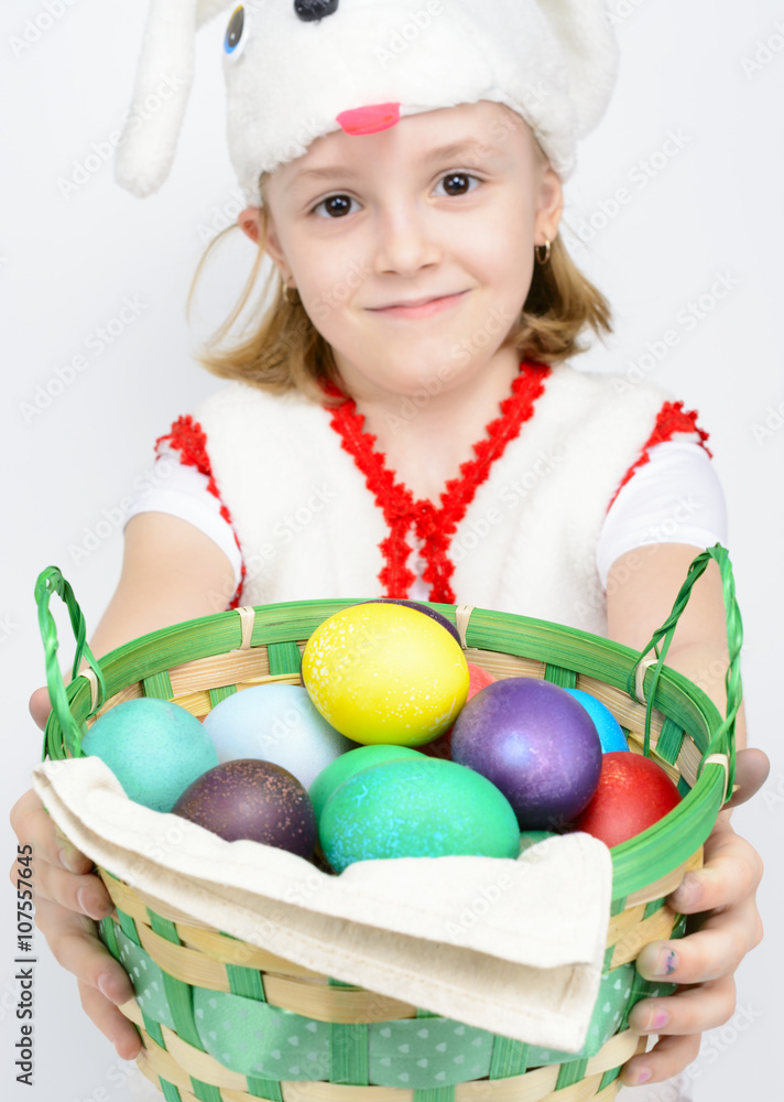 Girl in rabbit costume with a basket of Easter eggs Girl in rabbit costume with a basket of Easter eggs