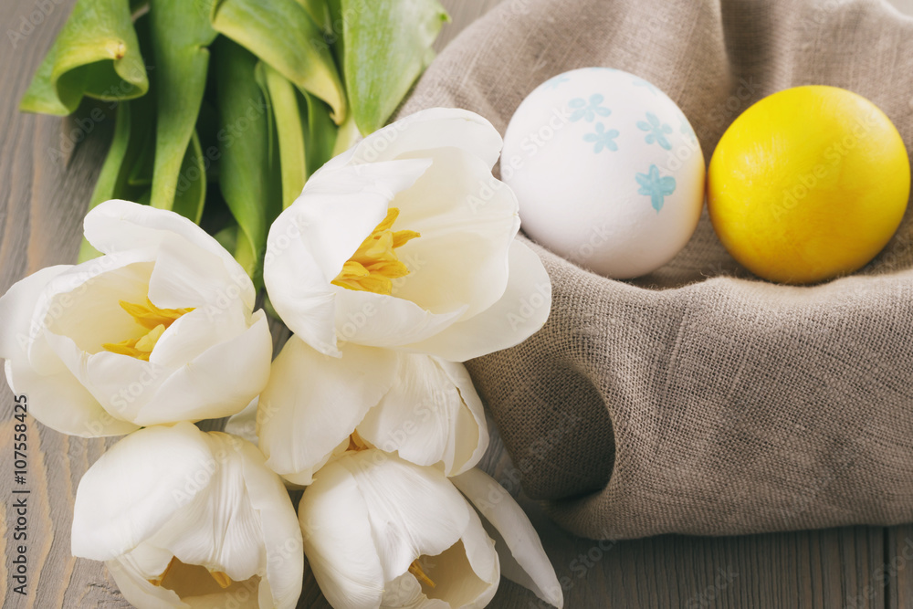 pastel color easter eggs with tulips on table, slightly toned photo pastel color easter eggs with tulips on table, slightly toned photo