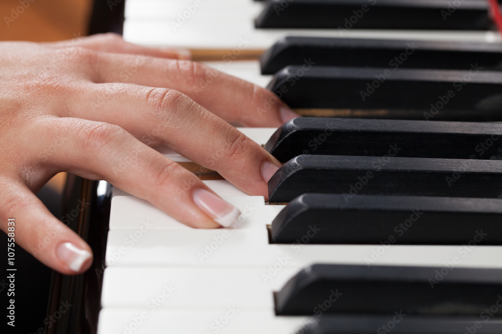 Fototapeta premium A woman playing piano