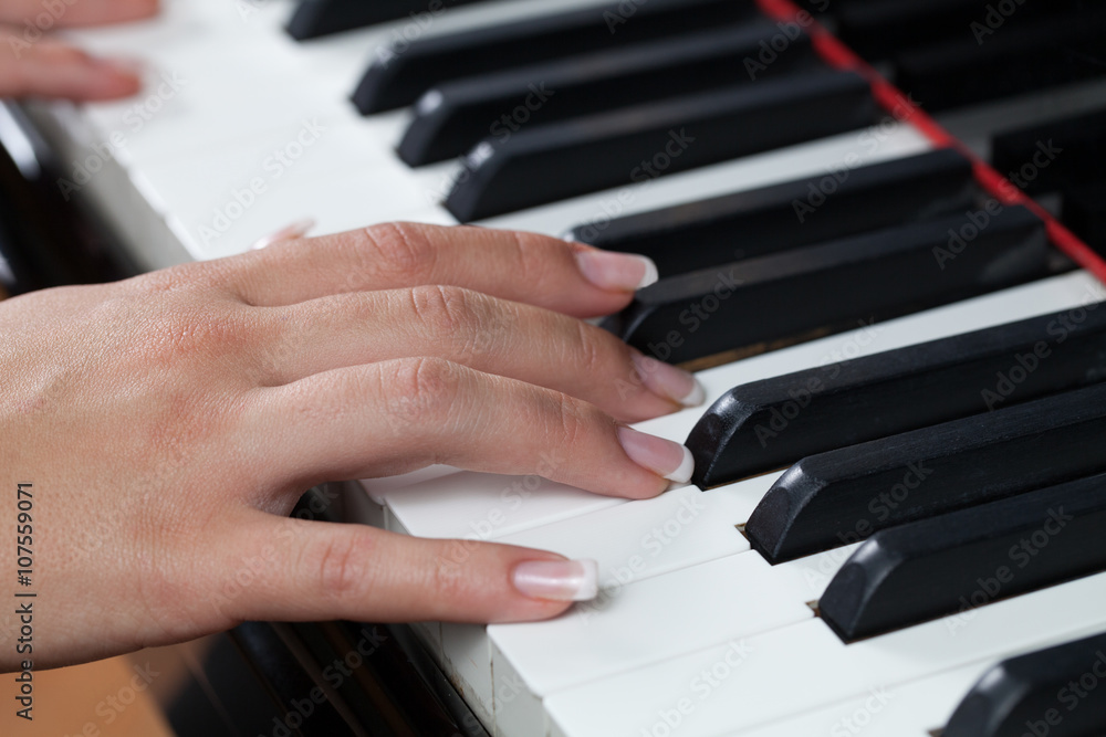 Fototapeta premium A woman playing piano