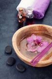 Spa background with orchids, bath oil and stones zen