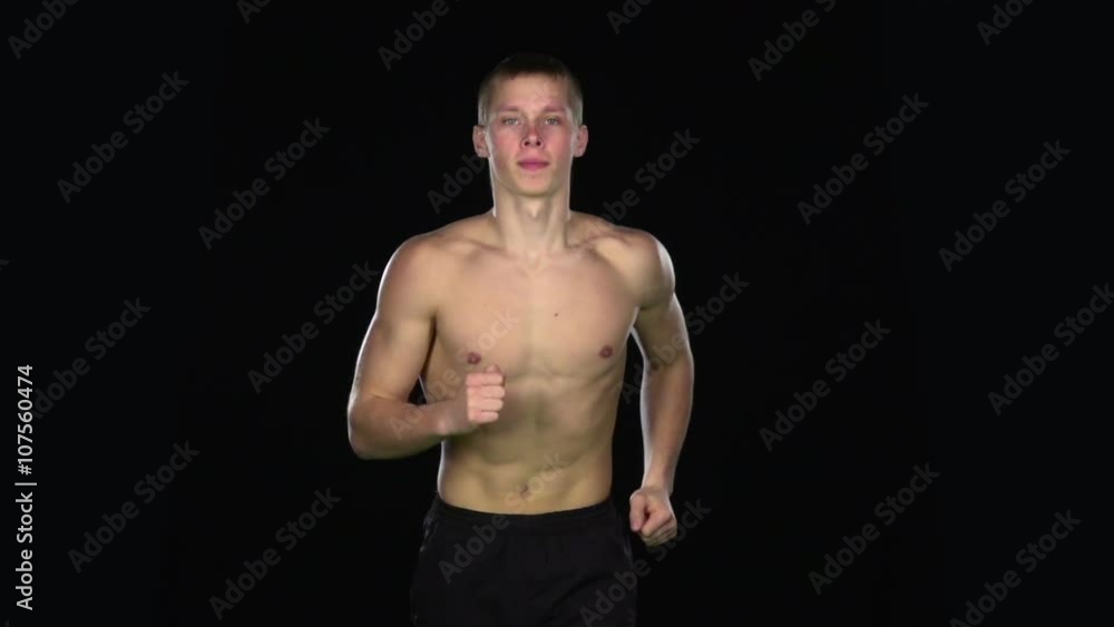 Sports man running. Black. Slow motion Sports man running. Black. Slow motion
