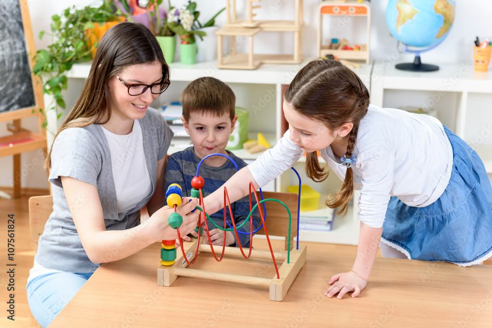 Kids and Kindergarten Teacher Playing with Bead Roller Coaster Kids and Kindergarten Teacher Playing with Bead Roller Coaster