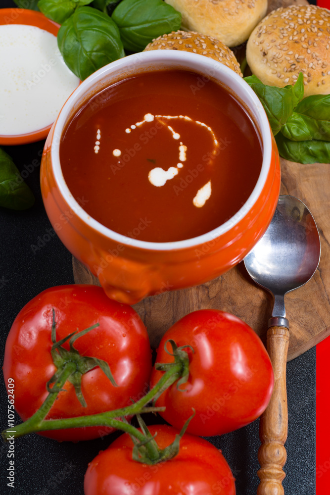 Fresh tomato cream- soup with green basil and bread Fresh tomato cream- soup with green basil and bread