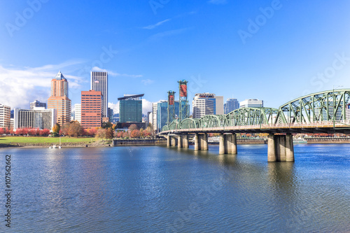 steel bridge over water with cityscape and skyline in portland