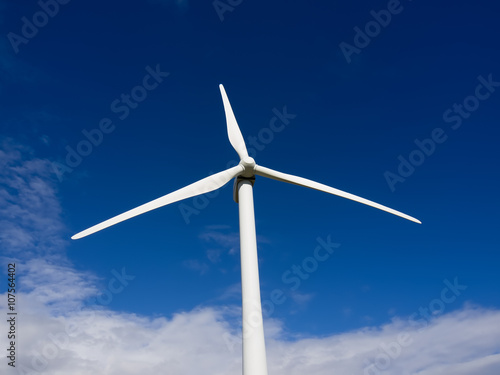 Wind turbine front view on blue sky