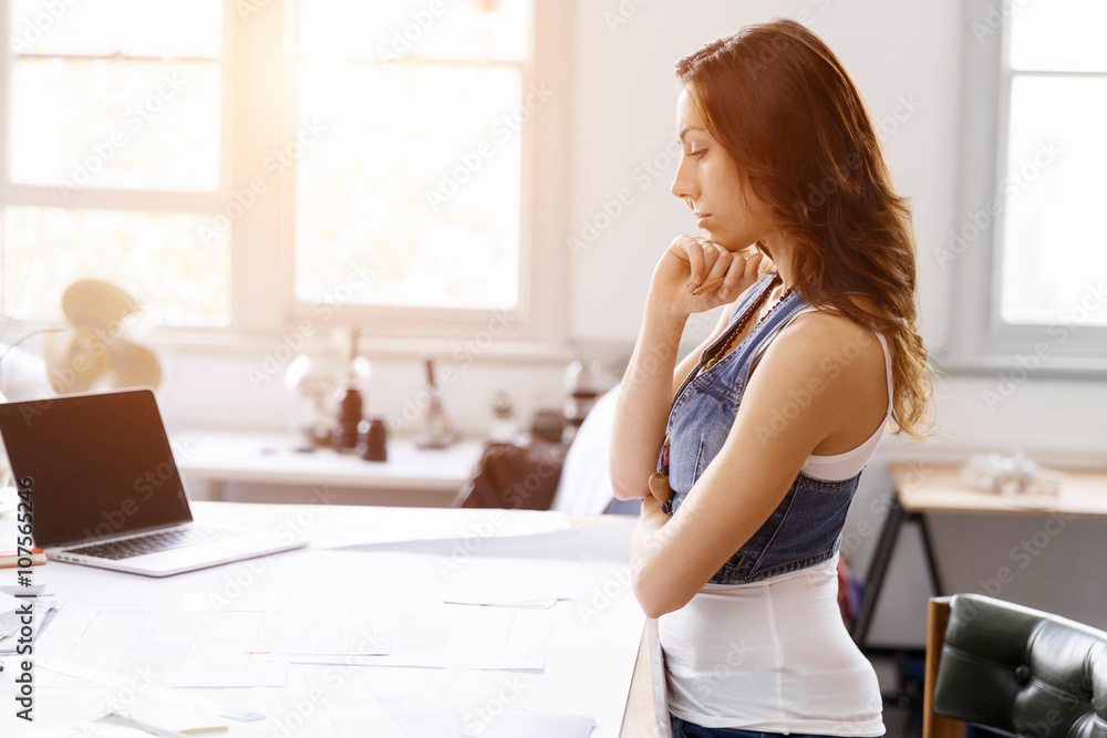 Young woman standing in creative office Young woman standing in creative office