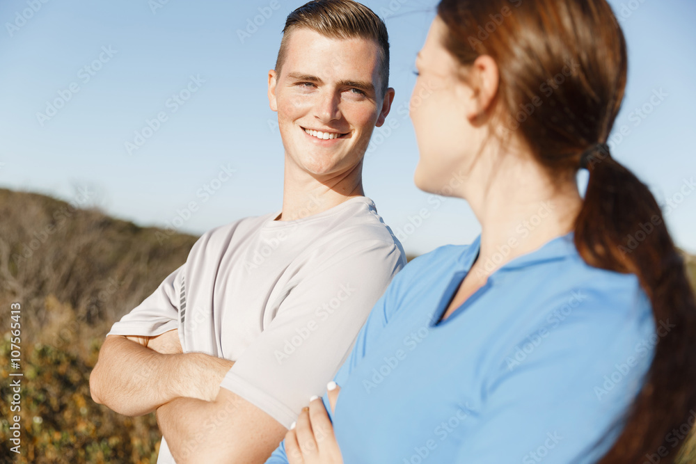Young couple on beach training together Young couple on beach training together