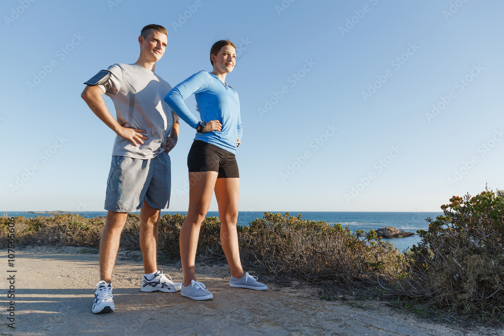 Fototapeta premium Young couple on beach training together