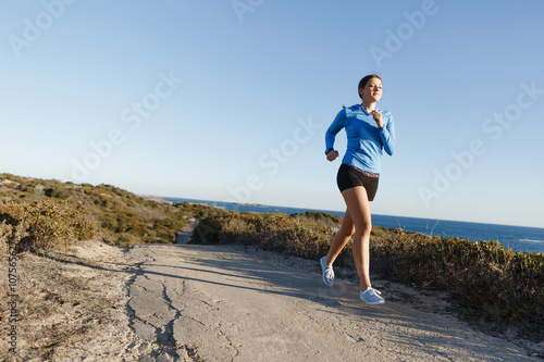 Sport runner jogging on beach working out © Sergey Nivens
